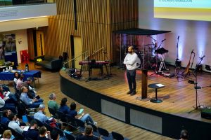 Santhosh Thomas speaking at the Reach Conference 2026